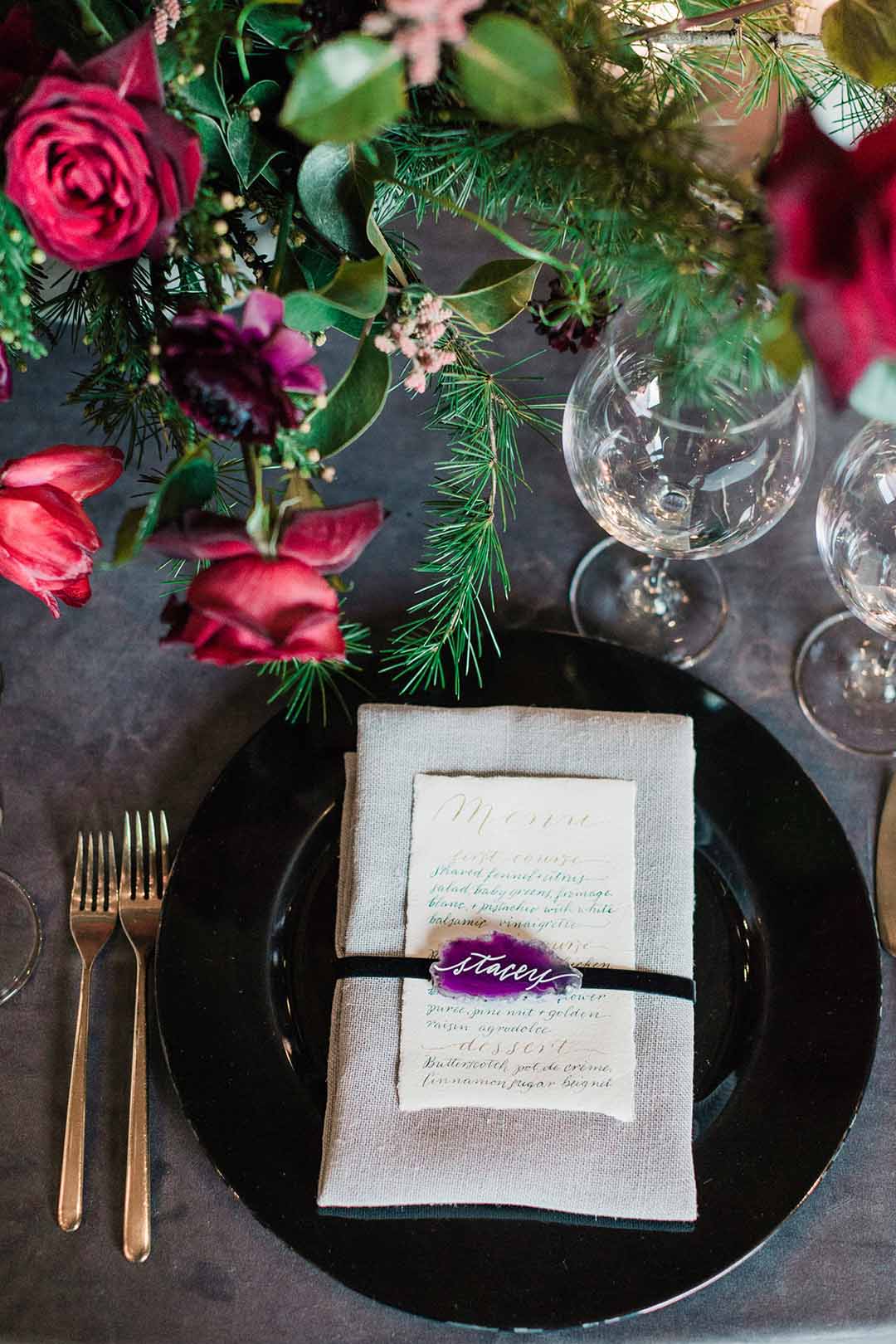full place-setting with purple agate name card, hand calligraphy menu, and red flowers