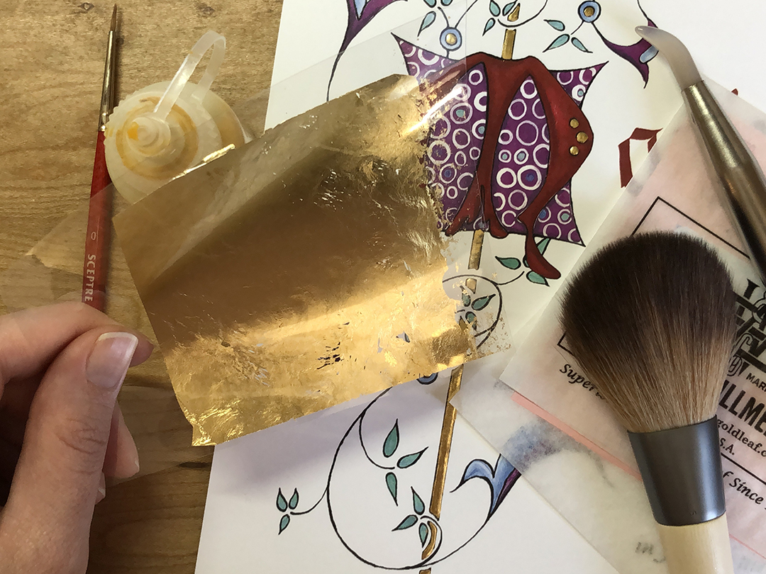 collection of tools used in gilding with decorated M behind