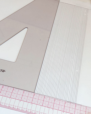Lining another sheet in ink with grid ruler & triangle square by Katie Leavens